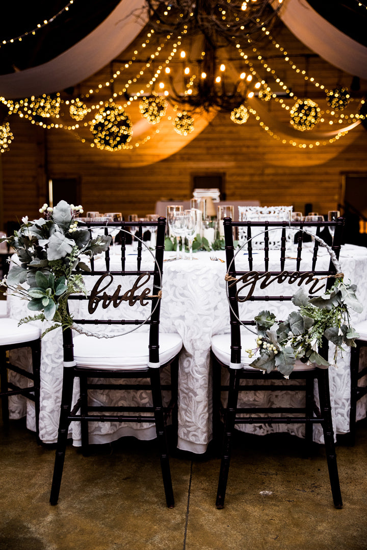 Two decorated black chairs labeled