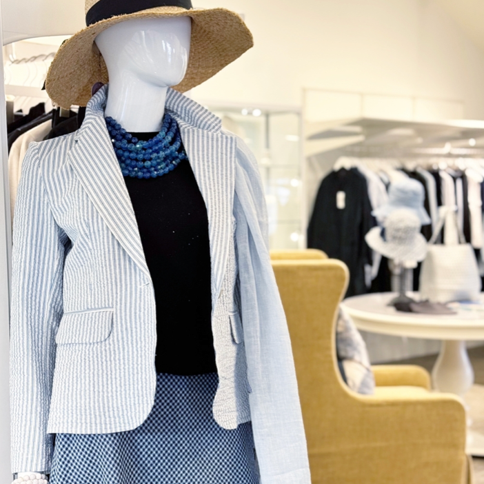 A mannequin wearing a hat and jacket.