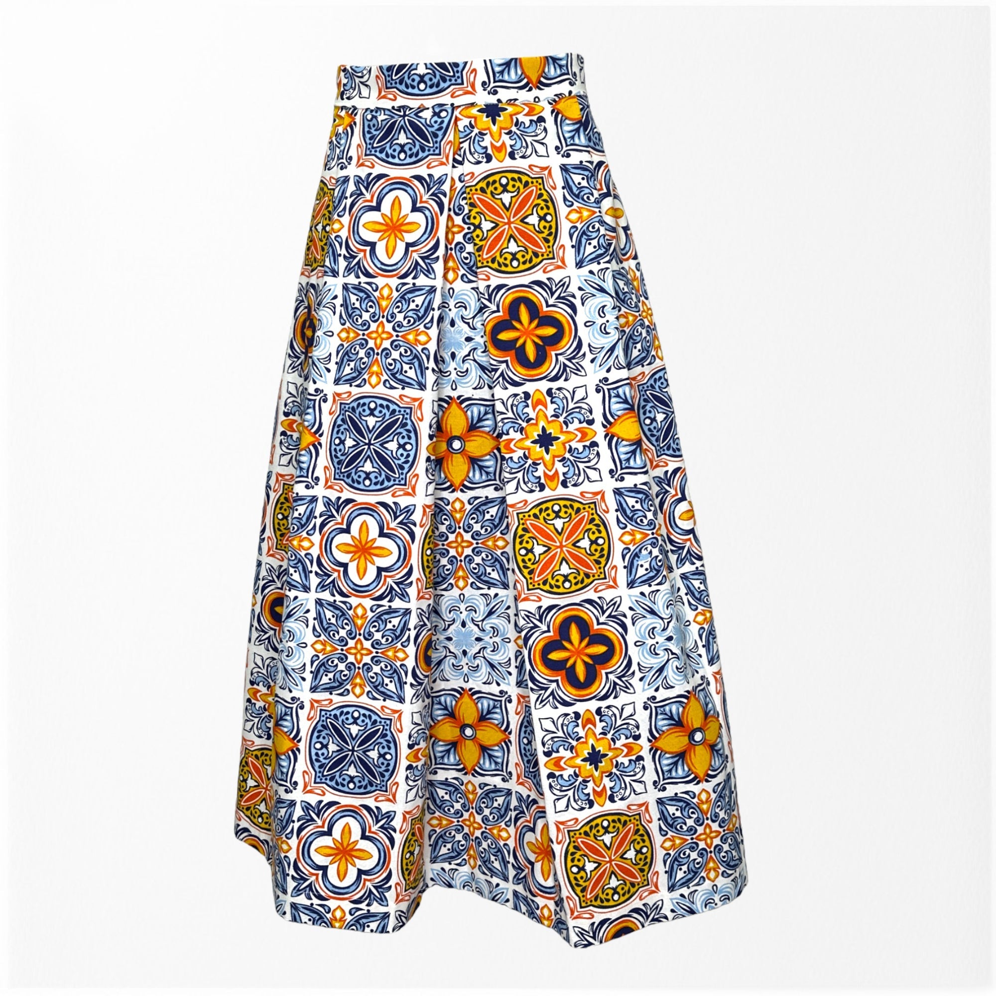 A high-waisted, flared midi skirt featuring a vibrant tile-inspired pattern in blue, orange, yellow, and green on a white background. The skirt has a structured silhouette and colorful, intricate geometric motifs.