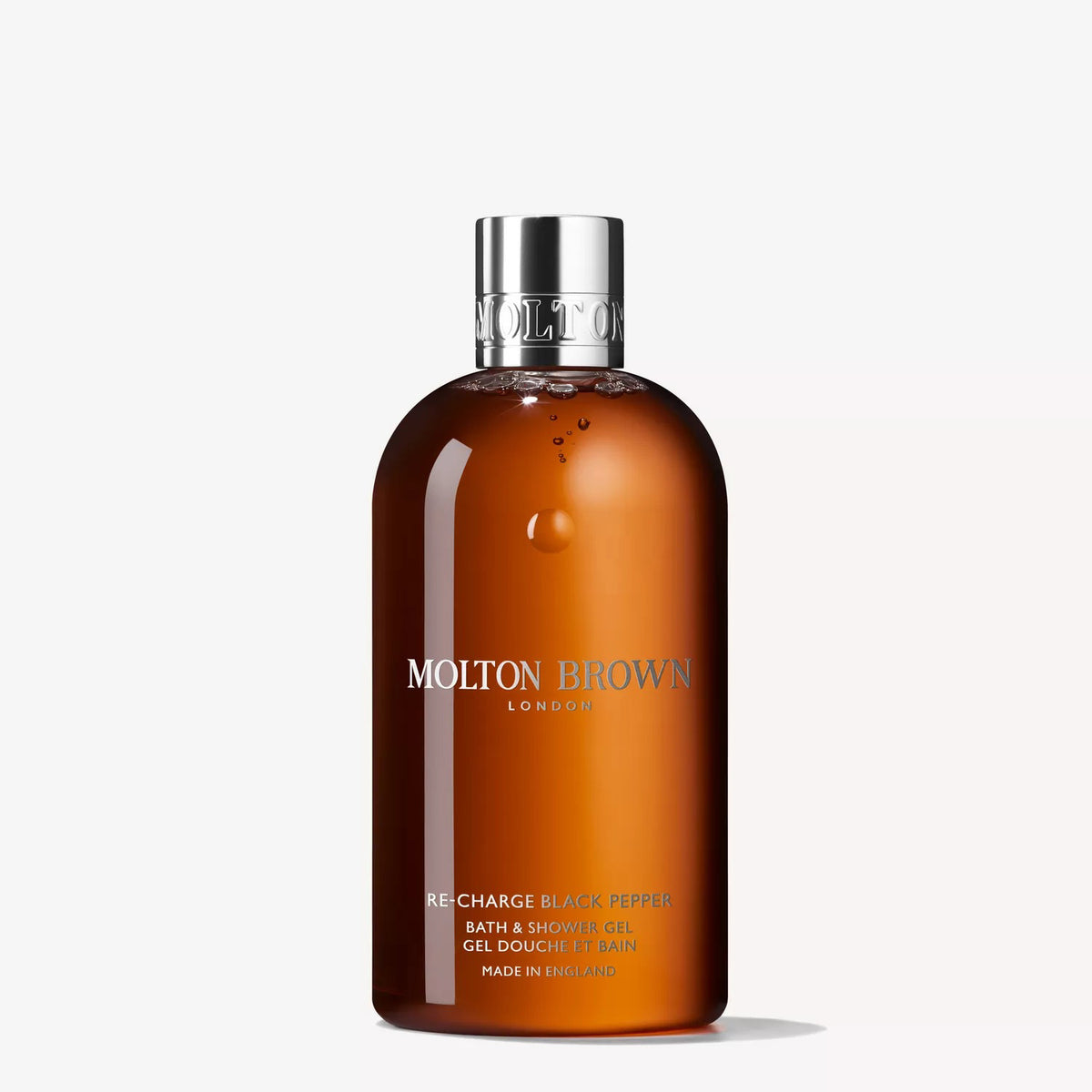 A bottle of MOLTON BROWN RE-CHARGE BLACK PEPPER Bath and Shower Gel, featuring a silver cap and amber gel inside, stands against a plain white background.