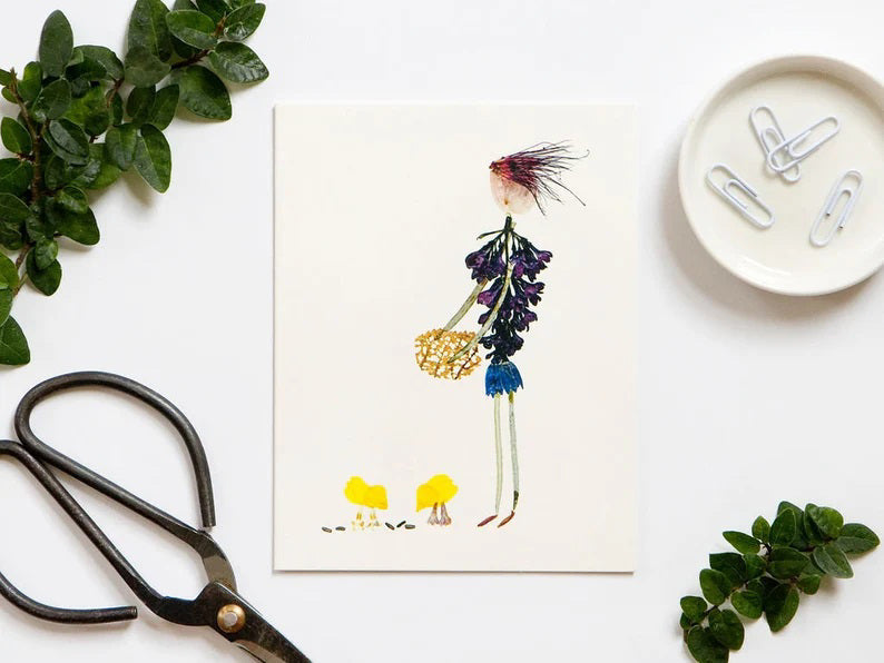 This botanical art print by Petal People Press, titled the Barnyard Party Card, features a whimsical character crafted from dried flowers and leaves, holding what appears to be a bouquet. The charming fusion of purple and green alongside yellow flowers reminiscent of baby chicks stands out against the white background, ideal for a farmyard country theme.