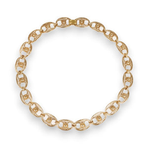 Introducing the GAS BIJOUX - CARTHAGE NECKLACE by GAS BIJOUX, a stunning gold-plated creation featuring interlocking oval links with intricate filigree cut-out designs that form a continuous loop. The nearly concealed clasp ensures a seamless appearance, perfecting the elegance of this exquisite piece. Photographed against a plain white background, its sophistication shines through effortlessly.