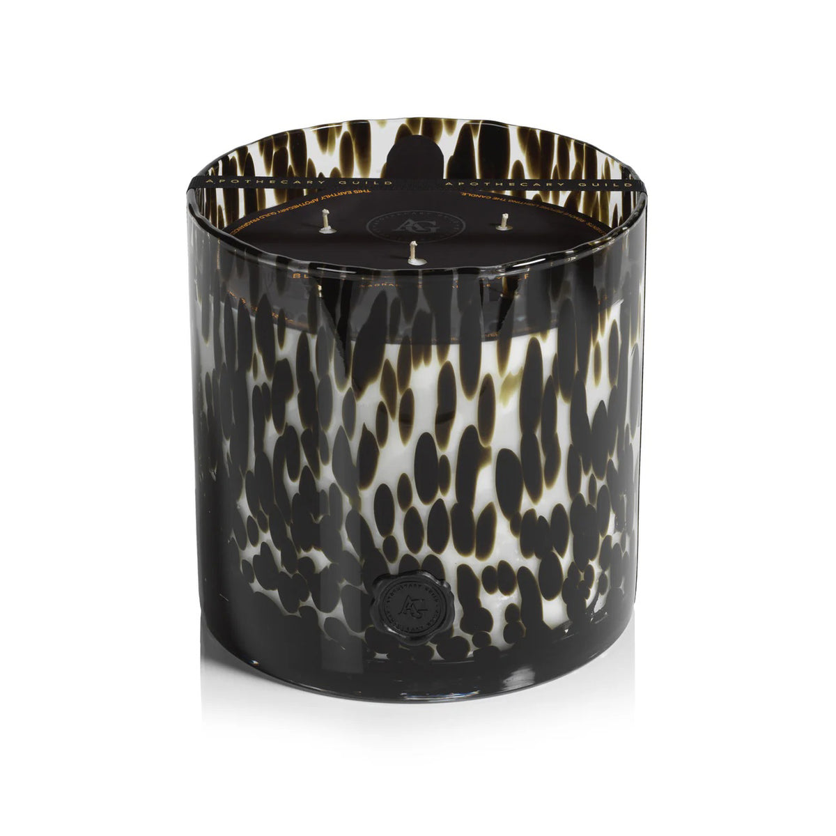 The ZODAX APOTHECARY GUILD Opal Glass 3 Wick Candle in Black Fig features a glossy tortoiseshell-patterned glass and offers a luxurious, long-lasting burn—perfect for creating an elegant atmosphere. Shown on a crisp white background.