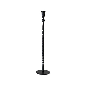 A set of four HAND FORGED CAST IRON TAPER HOLDERS by CREATIVE COOP, paired with beige spiral candles, stand on a plain, light-colored surface against a light gray background. The varied designs and heights of these tall black candlesticks add an elegant and minimalist aesthetic while infusing rustic charm into the scene.