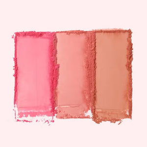 Two makeup palettes, each a JASON WU - BLUSH TRIO from JASON WU BEAUTY, are displayed with three glowing colors. The left blush palette features orange, peach, and pink tones, while the right includes pink, mauve, and rose shades. Swatches of the colors are blended below each corresponding palette.