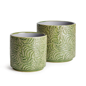 NAPA HOME AND GARDEN's IVANA POT LARGE features two cylindrical ceramic pots adorned with intricate vine motifs and green foliage, showcasing detailed fern-like designs on the exterior, while the interior remains smooth and unadorned.