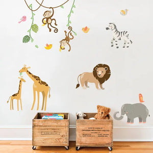 SIMPLE SHAPES - JUNGLE ANIMALS REMOVABLE WALL DECALS by SIMPLE SHAPES offer a vibrant collection of cartoon animals, including monkeys swinging from vines, colorful birds, a playful zebra, a giraffe and its calf, an adorable lion, and an elephant with a bird perched on its back. To enhance the scene, two wooden crates filled with stuffed toys and books are placed below for added charm.