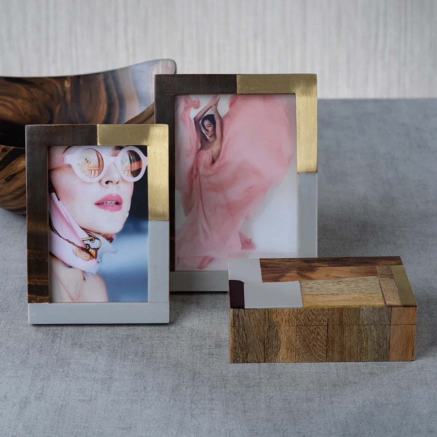 The ZODAX CAPE TOWN PHOTO FRAME - 4X6 features a modern rectangular design with brown wood, gold, and silver metal sections. This upright glass frame displays floral line art and the &quot;ZODAX&quot; logo.