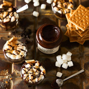 A jar of STONEWALL KITCHEN- BITTERSWEET CHOC SAUCE, featuring a green lid and a white label with green and brown text, labeled gluten-free with a net weight of 354 grams (12.5 oz). A classic from STONEWALL KITCHEN, renowned for its rich chocolate flavor, making it ideal as a hot fudge sauce.