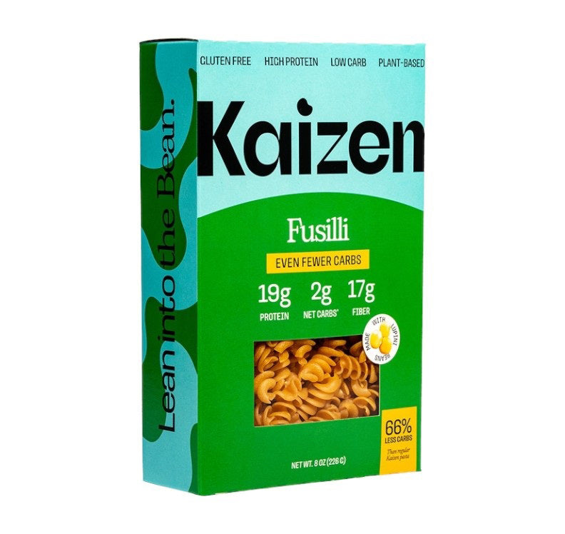 An image of a box of KAIZEN - FUSILLI pasta from KAIZEN FOOD COMPANY highlights its gluten-free, high protein, low carb, and plant-based attributes. The details on the box state: "19g Protein, 2g Net Carbs, 17g Fiber" per serving and feature the phrase "Lean into the Bean" on the side. Each box contains 8 oz (227g).