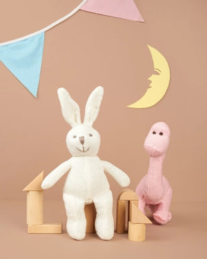 The DARK PINK KNITTED DIPLODOCUS TOY from BEST YEARS LTD stands against a white background. This soft, plush dinosaur features a long neck, small brown eyes, and short, stubby spikes along its back and tail. Its cozy texture makes it perfect for hugging—a delightful addition to newborn gifts.