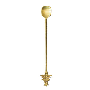 The BRASS COCKTAIL SPOON WITH TREE HANDLE by CREATIVE COOP is 8.5 inches long, featuring a rectangular bowl and a decorative, star-shaped tree handle at the end.