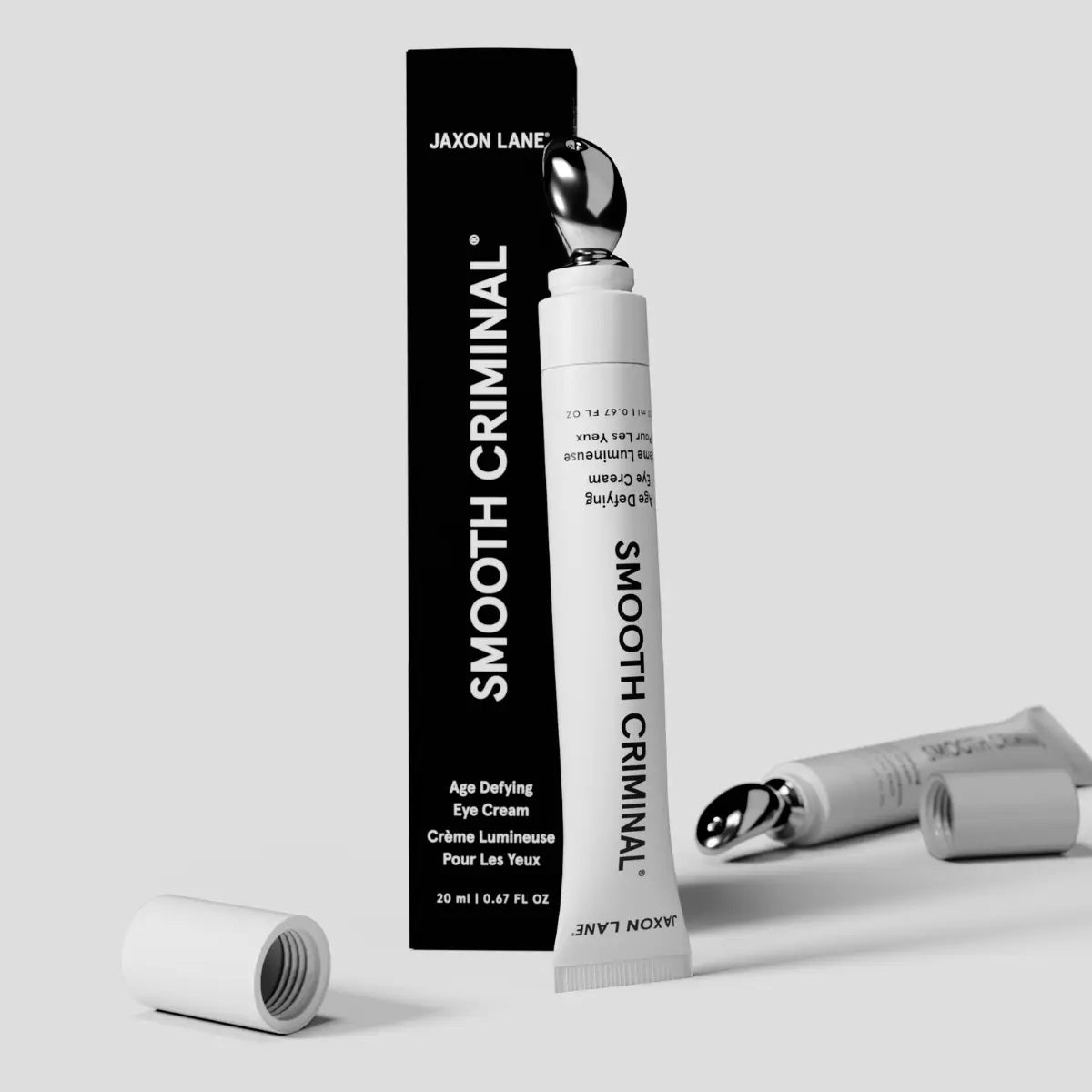 A white tube of JAXON LANE - SMOOTH CRIMINAL AGE DEFYING EYE CREAM for dark circles and under eye bags stands upright against a plain white background.