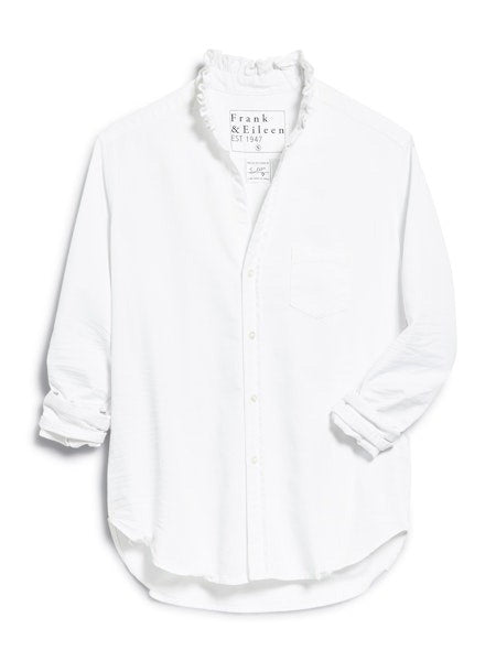 The FRANK &amp; EILEEN Ruffle Eileen Ruffle Collar Button Up Shirt in White Famous Denim features rolled-up long sleeves, a ruffled collar, and a single chest pocket, shown against a white background.