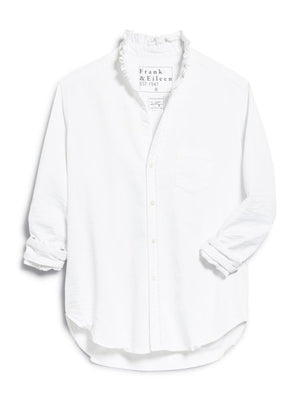 The FRANK & EILEEN Ruffle Eileen Ruffle Collar Button Up Shirt in White Famous Denim features rolled-up long sleeves, a ruffled collar, and a single chest pocket, shown against a white background.