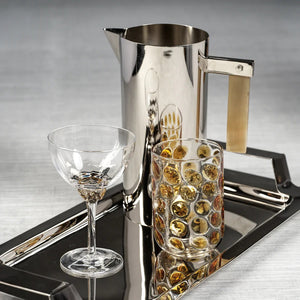 Introducing the MARTINI COCKTAIL OPTIC GLASS by ZODAX: a clear, elegant stemmed glass featuring a shallow, wide bowl. The glass boasts a detailed, decorative stem and a circular base. With a 150 ml capacity, its minimalist and sophisticated design is ideal for serving champagne or cocktails.