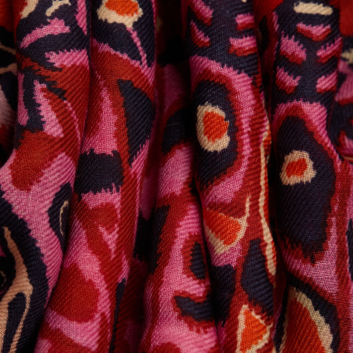 The INOUI EDITIONS PAPILLONS Square Wool Scarf in red features colorful butterflies in pink, orange, purple, and brown across a vibrant 130x130cm design—an eye-catching and versatile accessory for any occasion.