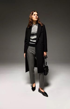 The SEVENTY Slim Fit Ankle Length Jacquard Vichy Stretch Pant is displayed from the back. These sophisticated, tailored pants feature a high waist and buttoned back pockets, with a slightly tapered leg fit. Made from textured fabric reminiscent of gingham jacquard, these ankle-length trousers embody both style and elegance with their black and white houndstooth pattern.