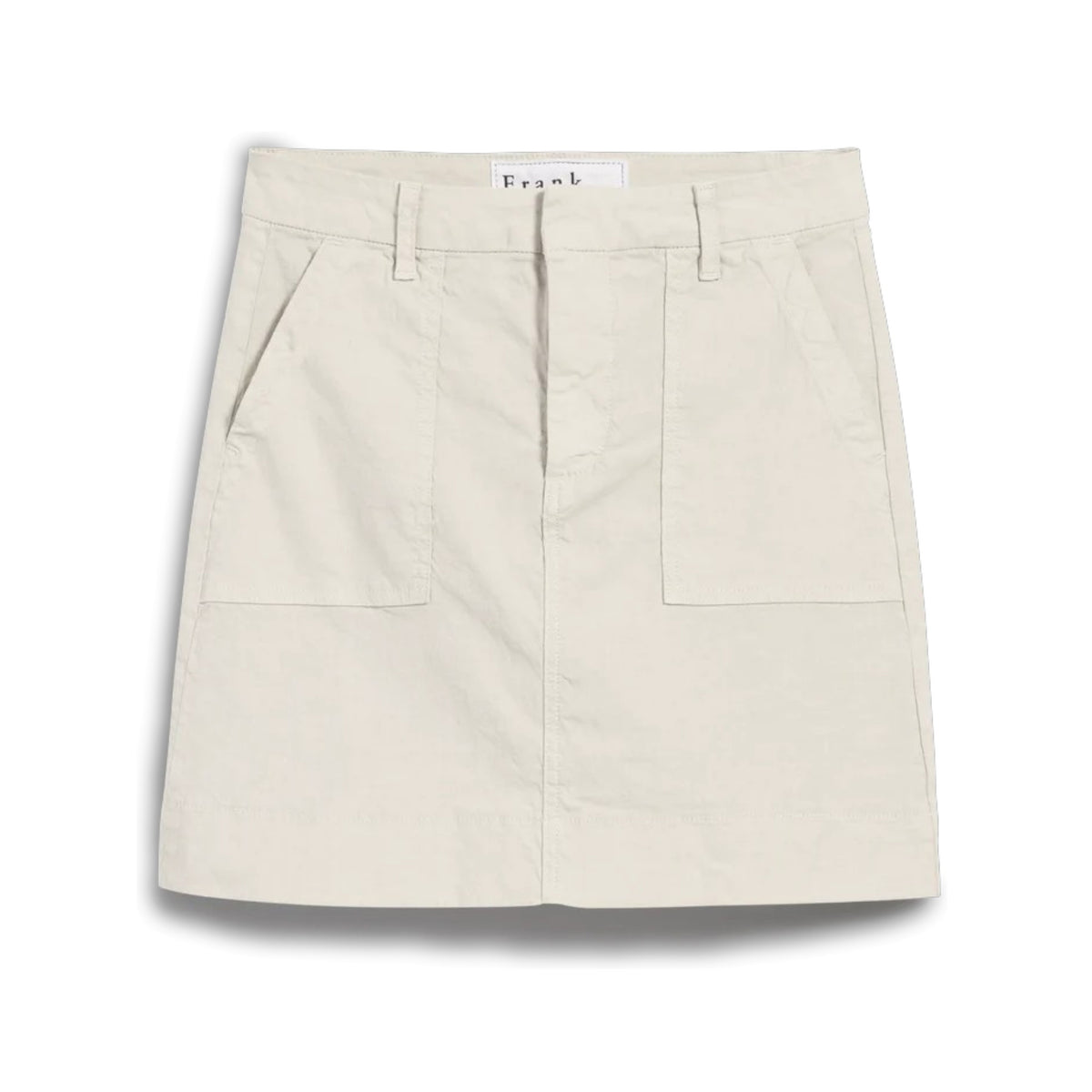 The FRANK &amp; EILEEN Jameson Utility Skirt in Cement is a light beige, knee-length skirt with belt loops, large utility pockets, and a front seam detail, crafted from Italian Performance Linen and shown against a white background.