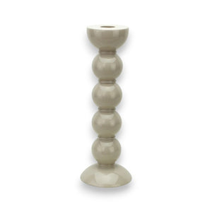 Introducing the ADDISON ROSS LONDON - TALL BOBBIN CANDLESTICK 24CM, a beige ceramic candlestick with a modern, minimalist design. It showcases four spherical shapes stacked vertically on a widening base, creating an elegant appearance reminiscent of traditional tall candlesticks. The top features a small dish that is perfectly designed to hold a single candle.