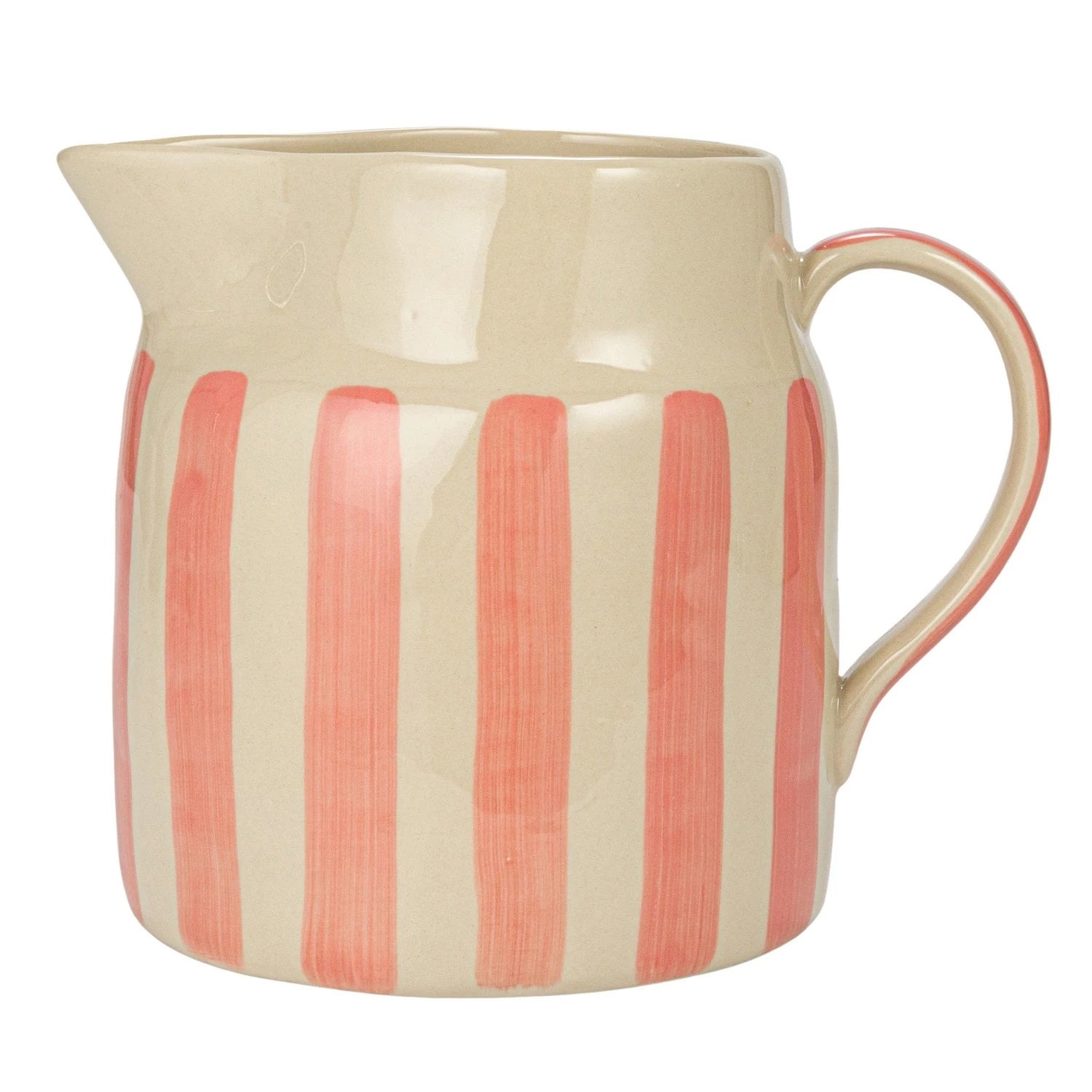 Two Creative Coop 1 3/4 Quart Pitchers with vertical stripes, one featuring blue and orange hues and the other in pink, rest elegantly on a stack of books atop a light-colored surface. The neutral background ensures that these vibrant hand-painted stoneware pitchers take center stage.