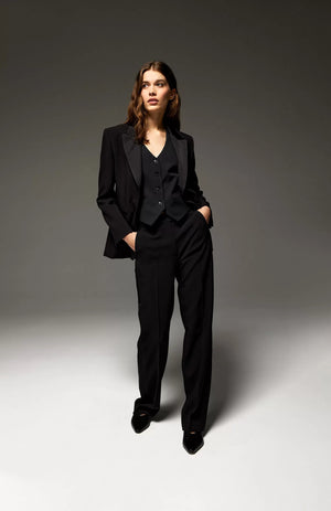 The SEVENTY Elegant Pant Suit comprises a black bi-stretch double poly single-breasted jacket and matching slim pants. The blazer features a single button closure, notch lapel, and two front flap pockets, while the straight-legged trousers offer a clean, classic cut ideal for formal or professional settings.