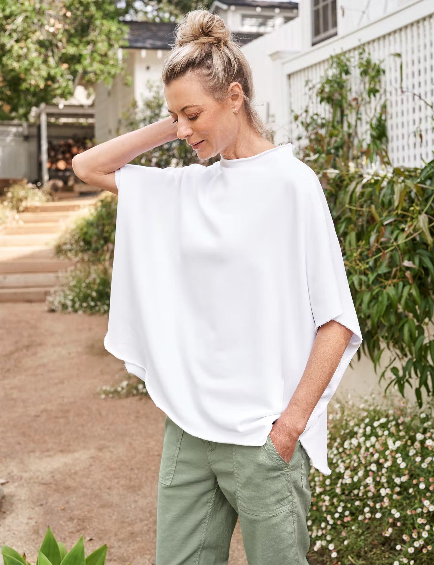 The FRANK & EILEEN - OLIVE ORIGINAL CAPELET is showcased against a light textured background. The fabric looks soft with a slight drape, offering a casual style that adds versatility to any outfit.