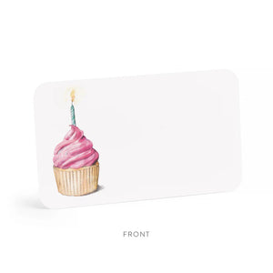 The "PINK CUPCAKE LITTLE NOTES" from E.FRANCES PAPER features an enchanting cupcake design with pink frosting and a lit candle. This adaptable card, characterized by its rounded corners and subtle logo, is elegantly displayed against a simple white background.