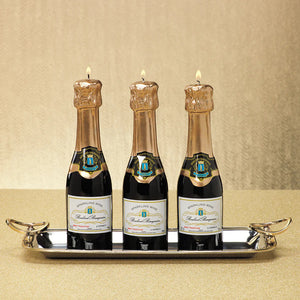 The MINI CHAMPAGNE BOTTLE CANDLE by ZODAX is designed to look just like a bottle of sparkling wine, featuring a dark green body, gold foil wrap, and intricate label. It has accurate dimensions with a wick that emerges from the top, closely resembling a champagne bottle while providing an impressive burn time.