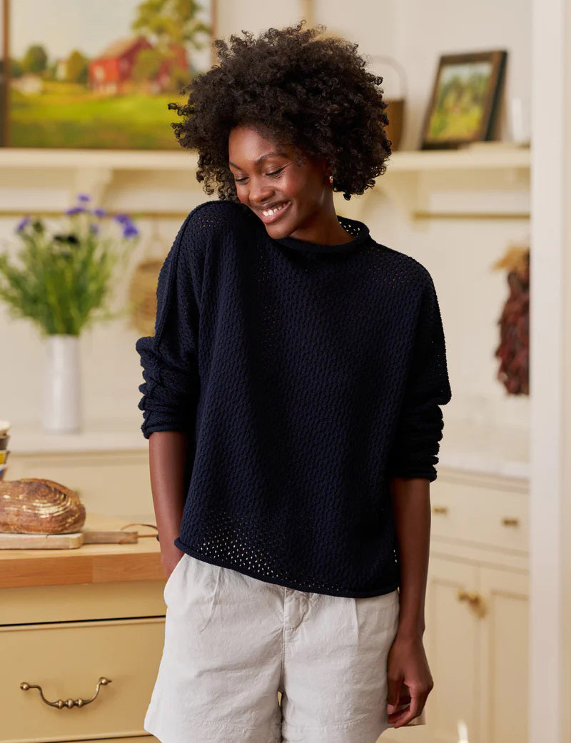 The FRANK &amp; EILEEN MONTEREY Pointelle Rolled Funnel Neck Sweater in Marine features a loose, textured Italian pointelle knit, long sleeves, high rolled neckline, and is crafted from 100% cotton. Shown laid flat on a white background.