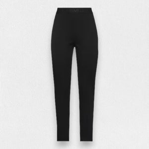 The MEIMEIJ - LEGGING is a sleek, high-waisted pair of black leggings with a fitted design. Made in Italy, they feature a smooth and stretchy viscose fabric with a subtle waistband label. The background is textured light grey.