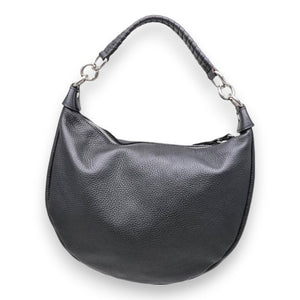 The LEATHER HANDBAG by LISA LIVI is a tan, genuine leather shoulder bag with a soft, textured surface. This Made in Italy handbag features a single strap with silver metal rings attaching it to the body. A zipper runs along the top edge for closure. Its sleek and minimalistic design makes it suitable for casual use.