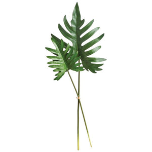 A vibrant Split Leaf Selloum Stem from Napa Home and Garden stands out with large, glossy green leaves in a modern vase. The background features geometric, intersecting lines, encapsulating a contemporary artisans' touch for home decor aficionados.