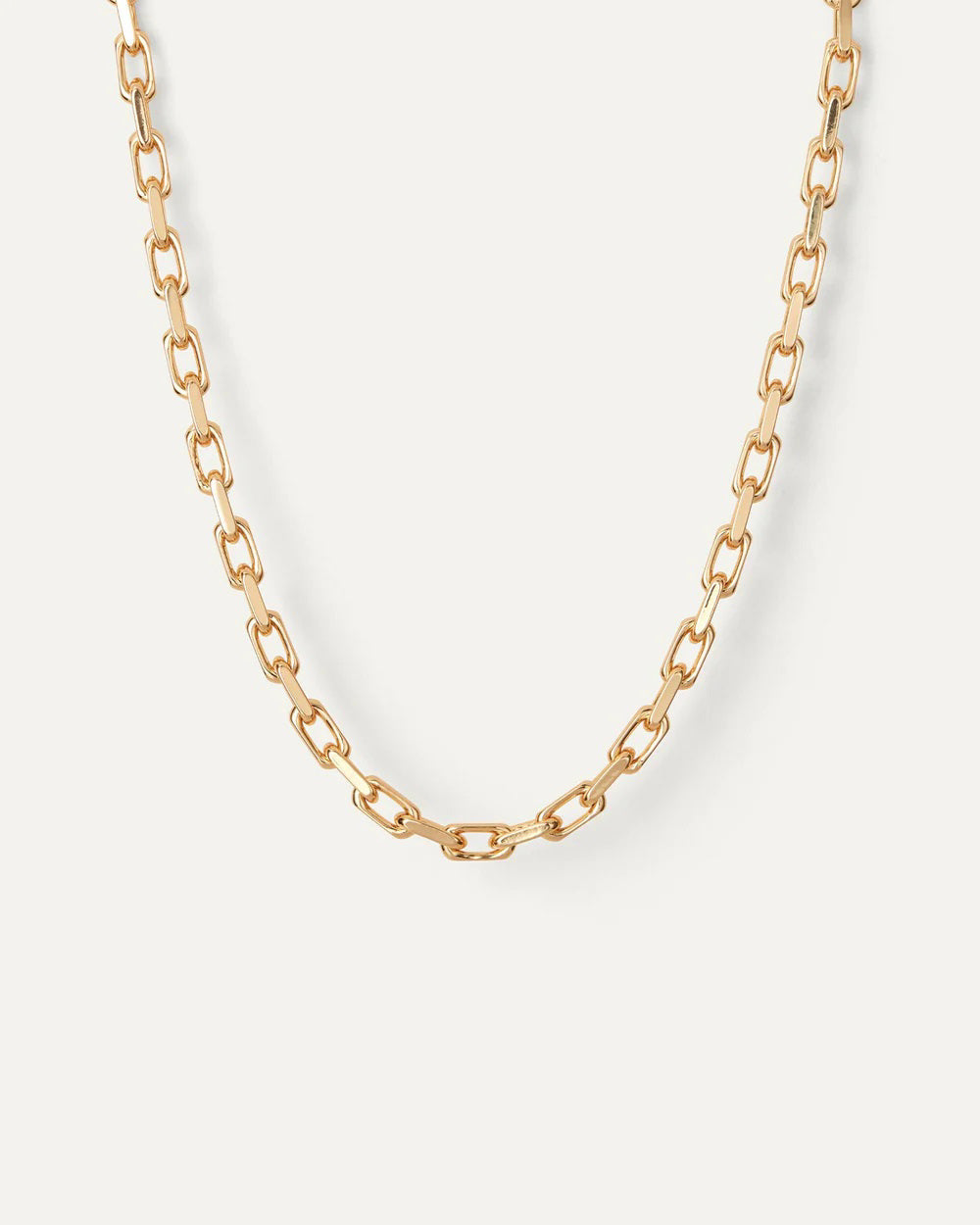 The JENNY BIRD - LOIRE NECKLACE features high-polish gold oval links in an irregular layout with a faceted cable link design, secured by a foldover clasp, set against a plain white background.