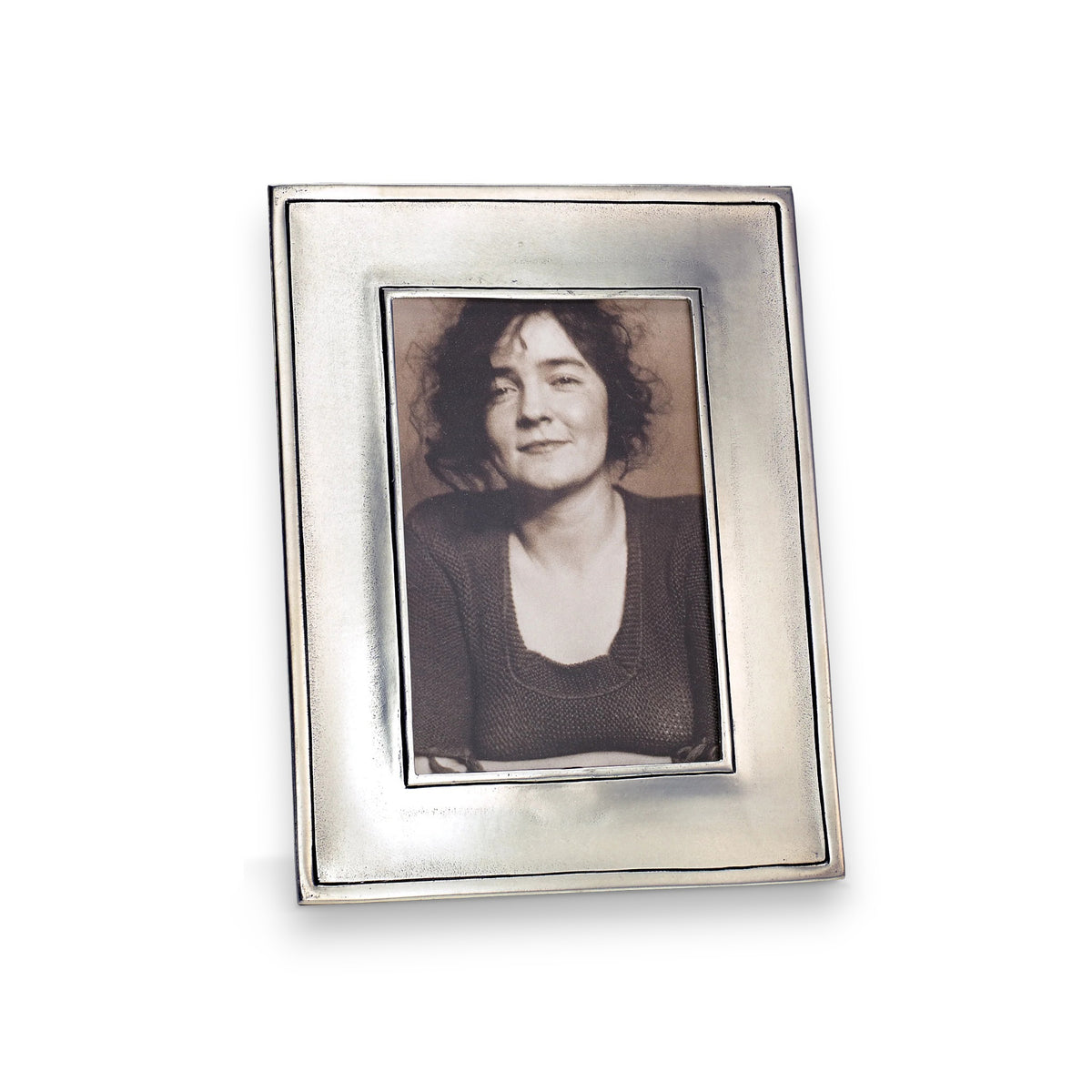 A black-and-white portrait of a smiling woman with curly hair in a knit top, displayed in the MATCH Lombardia Rectangular Pewter Photo Frame (Medium)—an elegant piece perfect for personalized gifts.