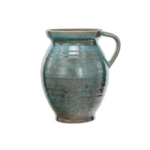 Introducing the 4 Quart Jug with Handle by Creative Coop: This ceramic jug features a glossy turquoise finish. It showcases a rounded body that subtly tapers towards the top, complemented by a wide lip and a single handle on one side. The handcrafted look and glaze variations imbue it with rustic charm, making it both functional and decorative.