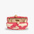 The KAYU AMI CLUTCH is a small pink raffia clutch with tan floral patterns, a beige interior, an optional gold chain strap, and a clasp featuring two wooden beads. The hand-embroidered charm is highlighted by the "Kayu" label inside.