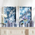 NAPA HOME AND GARDEN's "Aviary Cyano" prints showcase silhouettes of birds on tree branches in a textured blue backdrop, with intricately detailed white leaves and blossoms, offering a serene, nature-inspired aesthetic.