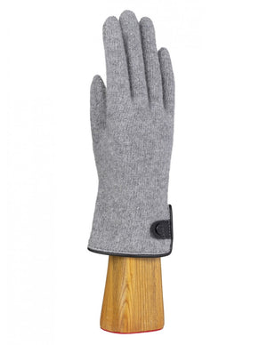 A KNIT WOOL AND CASHMERE GLOVE WITH RUFFLE from the SANTACANA MADRID WORLD GLOVE COMPANY is showcased on a wooden hand model, featuring teal cashmere with dark pink accents between the fingers and a decorative ruffled cuff adorned with a pink button.