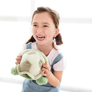 The STEIFF - TUGGY TORTOISE PLUSH TOY by STEIFF is an adorable green turtle lying on its stomach. It features a light green shell, dark green flippers, and a smiling face. Its fuzzy and cuddly flippers and head are made from super-soft fabrics, making it an inviting and delightful stuffed animal.