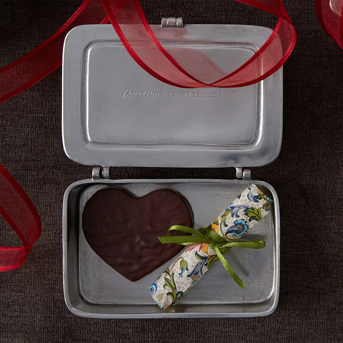 The MATCH - TUTTO E POSSIBILIE BOX LARGE is a rectangular pewter box with a hinged lid engraved &quot;TUTTO È POSSIBILE&quot; (&quot;Everything is possible&quot;), making this MATCH piece an elegant and inspirational gift.