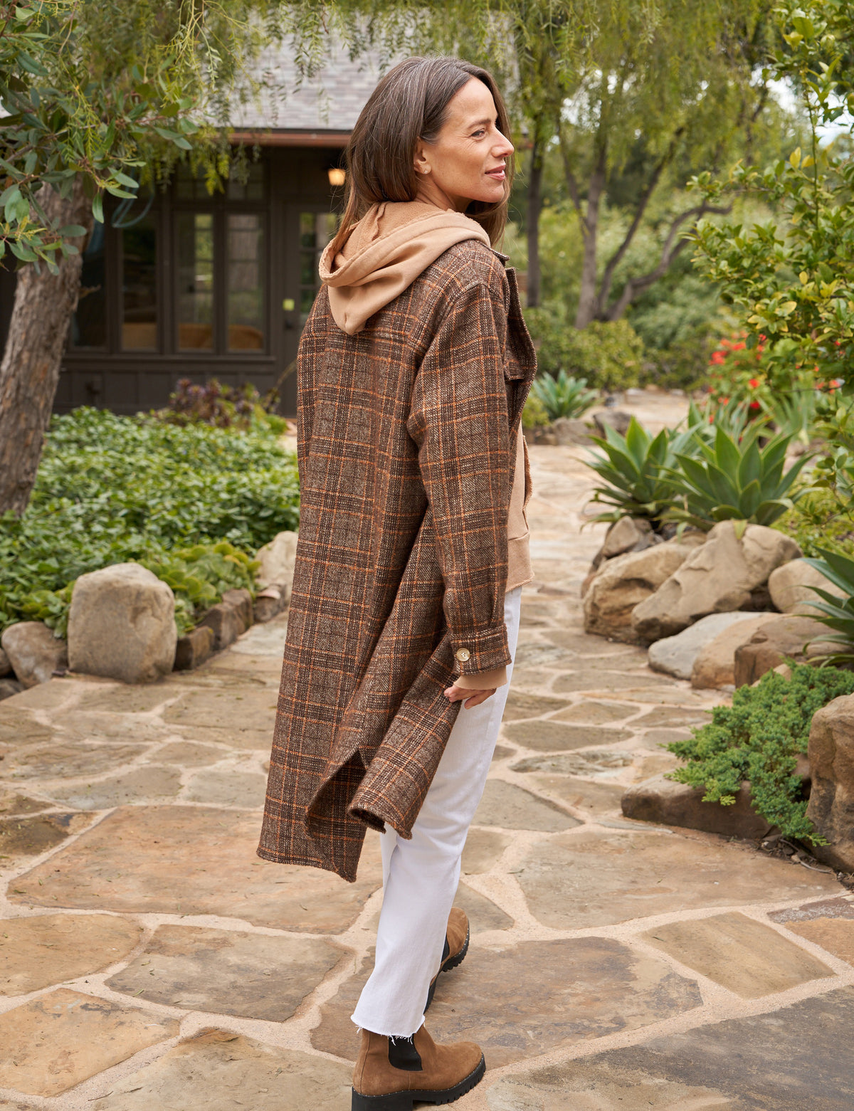 The Gavin Italian Boucle Shirt Jacket from Frank &amp; Eileen is a long, plaid coat in shades of brown with an oversized fit. Made from luxurious pre-washed wool, the coat features a collared neckline, button closure, and two large front pockets. Sleeves are rolled to mid-length and the fabric showcases a textural, woven appearance. The tag inside reads &quot;Frank &amp; Ellen.