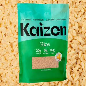 A green and light blue bag of KAIZEN - RICE by KAIZEN FOOD COMPANY is displayed. The packaging highlights key features such as being gluten-free, high protein, low carb, keto-friendly, and plant-based. The bag contains 8 ounces (226g) of rice with 20g of protein, 6g net carbs, and 15g fiber per serving.