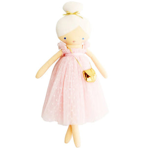 The ALIMROSE - CHARLOTTE DOLL PINK by ALIMROSE is a handcrafted doll with pale skin, dressed in a soft tulle light pink dress and carrying a golden purse. Her blonde hair is styled in a bun, and her small blue dot eyes coupled with a simple smile give her a charming expression.