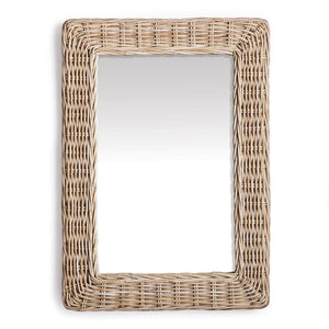 The Kylan Rectangular Mirror by Napa Home and Garden features a woven wicker frame, reflecting a gradient of light to dark tones. This decorative piece boasts earthy textures and rustic charm with its rattan look, enhancing any room’s aesthetic.