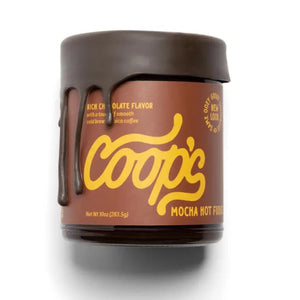 A jar of COOP'S - Cold Brew Mocha Hot Fudge from COOPS. The jar has a dark brown lid and label with yellow text, with the lid appearing to have a drip effect that simulates melted chocolate. The label highlights a rich chocolate flavor made with high-grade European chocolate and cold brew mocha coffee, and the net weight is 10 oz (283.5 g).