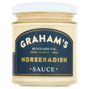 A jar of Graham's Irish Horseradish Mustard with a white lid. The label is navy blue with gold and white text, stating "Graham's Mustard Co. Estd 2014" on top and "Irish Horseradish Mustard" on the bottom. Perfect for pairing with roast beef, this creamy light beige sauce has earned great taste awards.