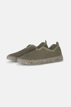 A pair of olive green ILSE JACOBSEN - THE TULIP SHOE from LINES OF DENMARK, featuring a perforated, breathable upper design made from recycled microfiber and a speckled, translucent natural rubber sole. The shoes are displayed at a three-quarter angle on a plain white background.