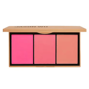 Two makeup palettes, each a JASON WU - BLUSH TRIO from JASON WU BEAUTY, are displayed with three glowing colors. The left blush palette features orange, peach, and pink tones, while the right includes pink, mauve, and rose shades. Swatches of the colors are blended below each corresponding palette.