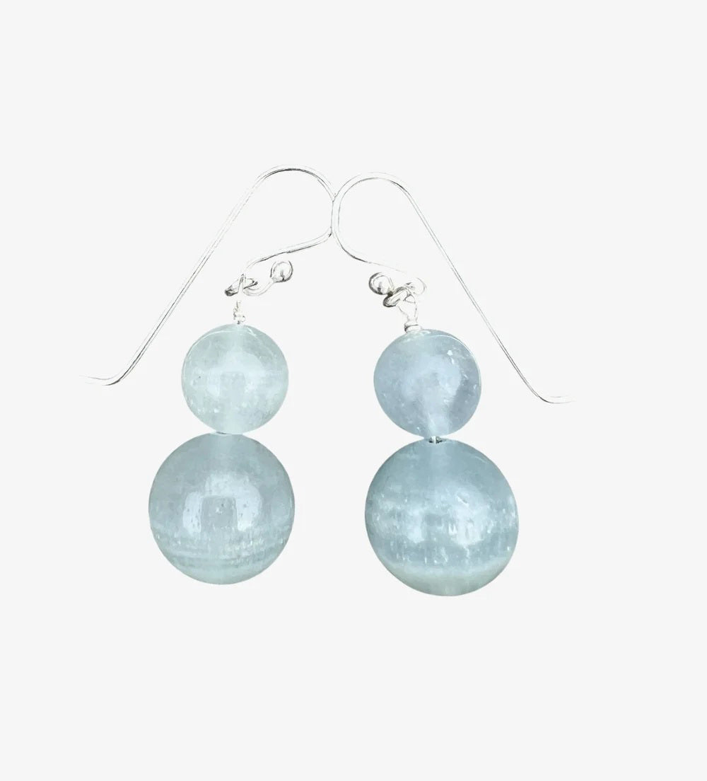 ANN LIGHTFOOT DOUBLE DROP BLUE CALCITE EARRINGS: Two round, translucent light blue calcite beads stacked vertically on each sterling silver hook, shown against a white background.